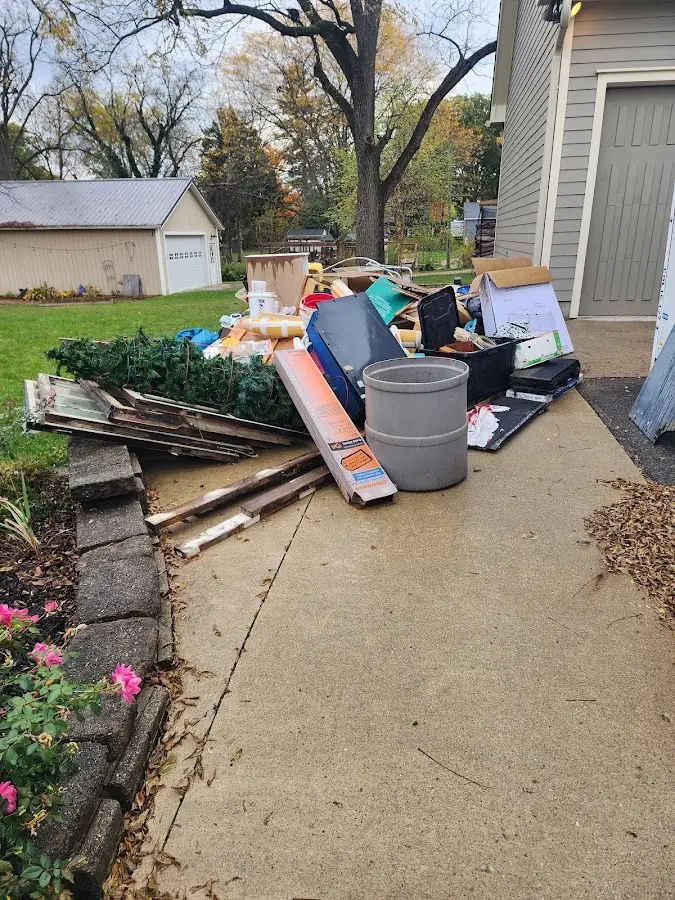 Dumpster being loaded with debris for 12 Yard Dumpster Rental in Trenton